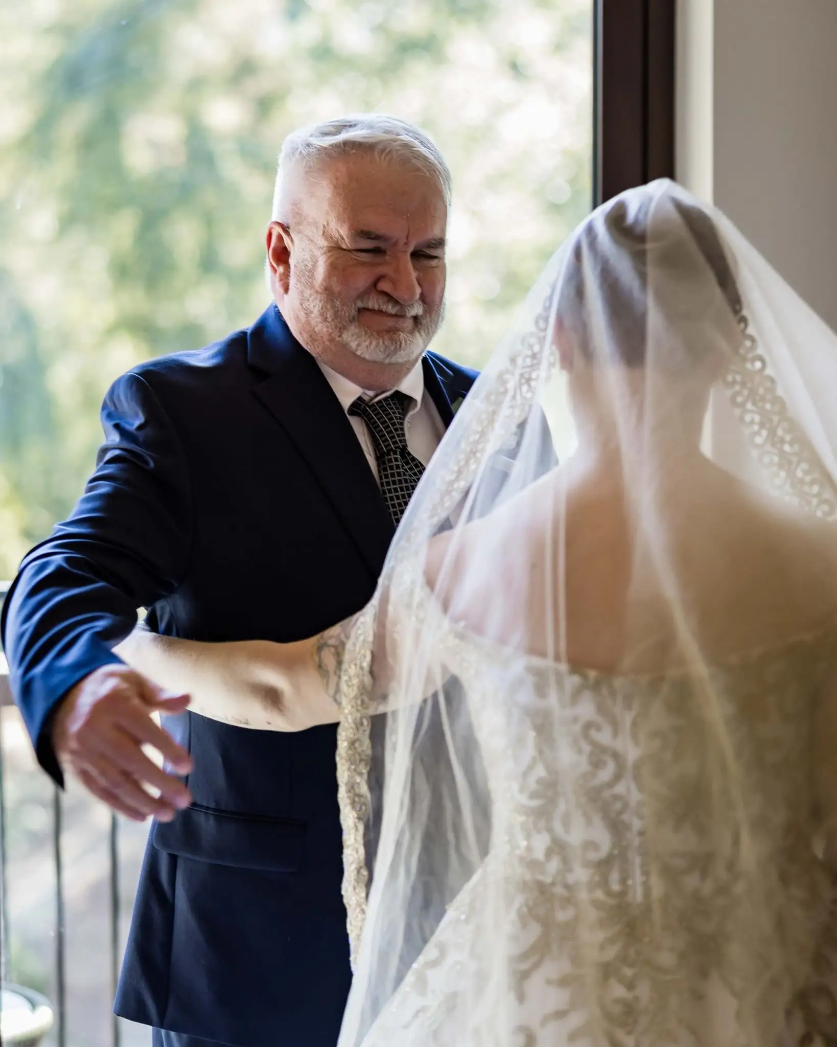 Jessica and Hayden wedding at Grand Bohemian Lodge Greenville, SC — the bride’s father reaching out to her in a window-lit room