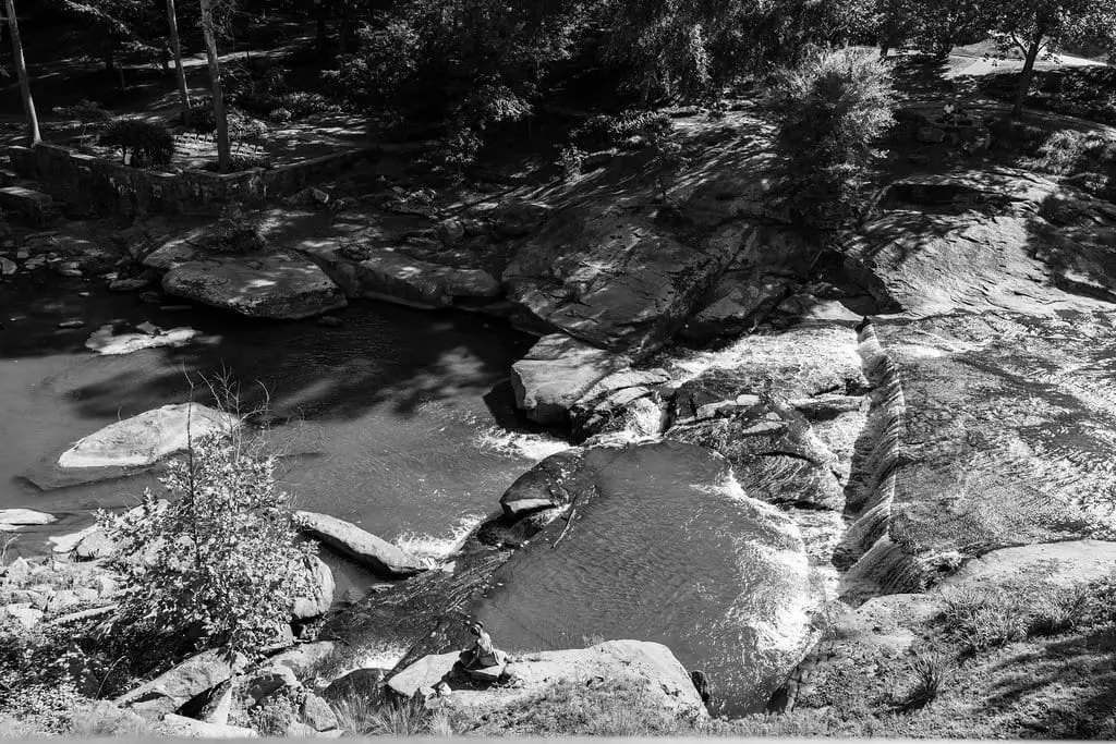 River rocks and quiet pools in black and white along the Greenville waterfront