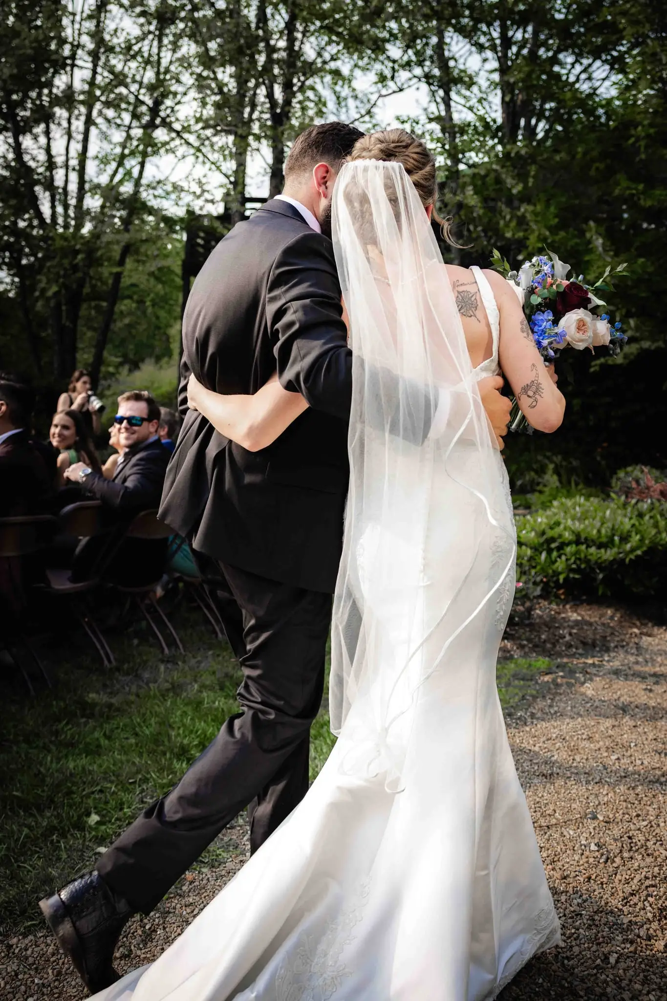 Anna and Joseph wedding at The Crest Center & Pavilion, Asheville NC — the couple hurrying back up the aisle as the bride's veil flies