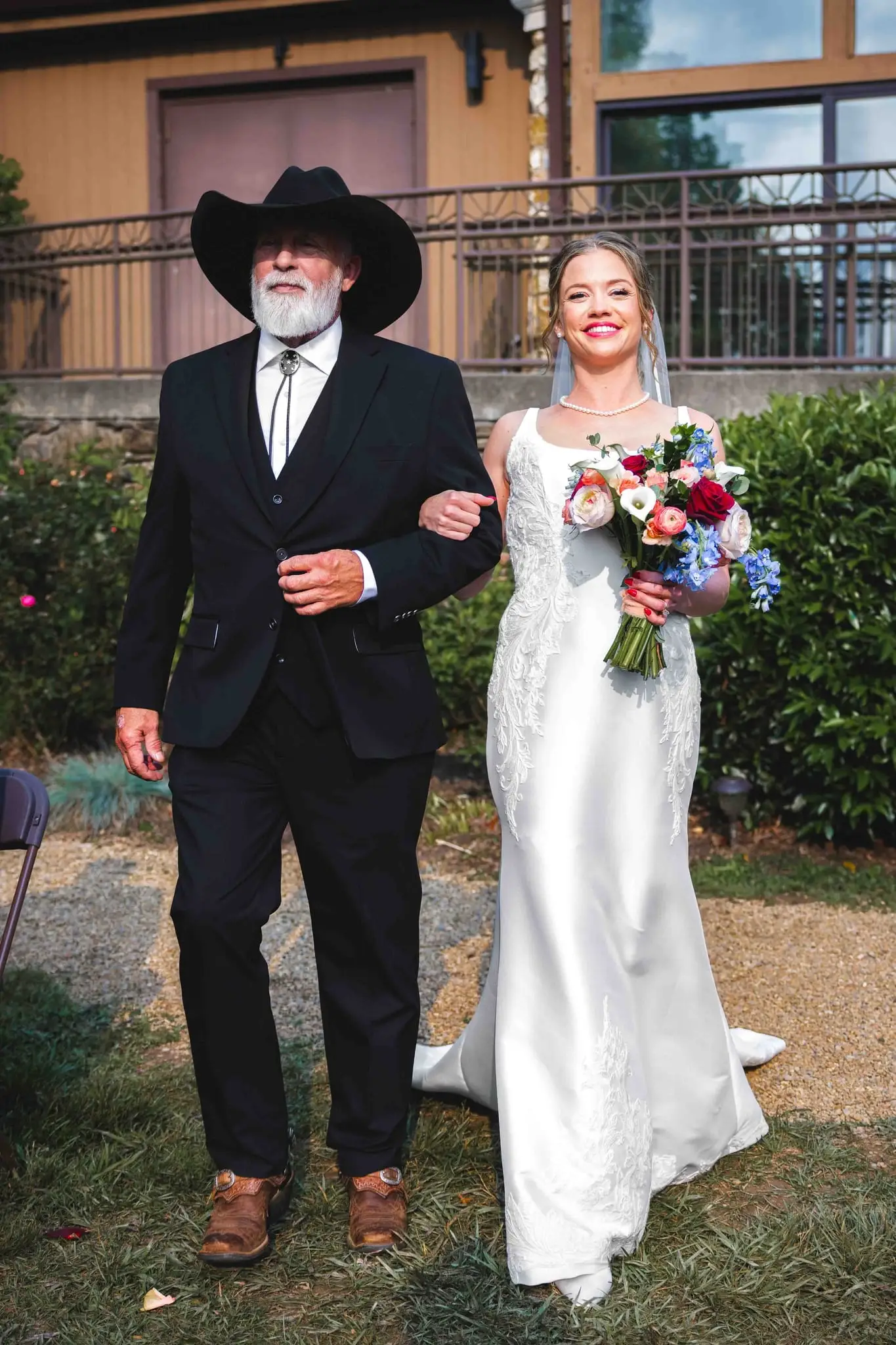 Anna and Joseph wedding at The Crest Center & Pavilion, Asheville NC — a man in a cowboy hat walking the bride along a garden path
