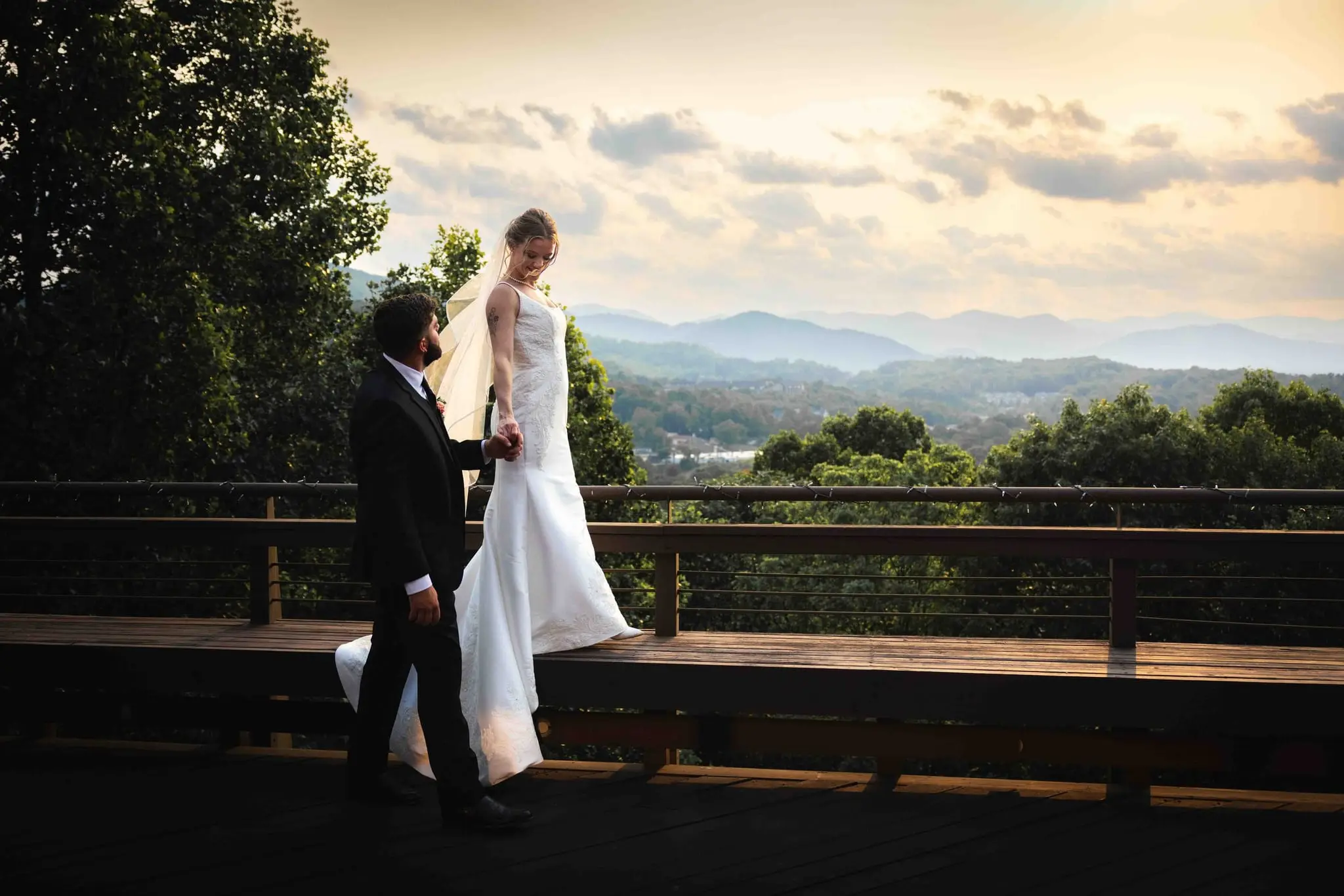 A couple at sunset above layered Blue Ridge mountains at the Crest Center