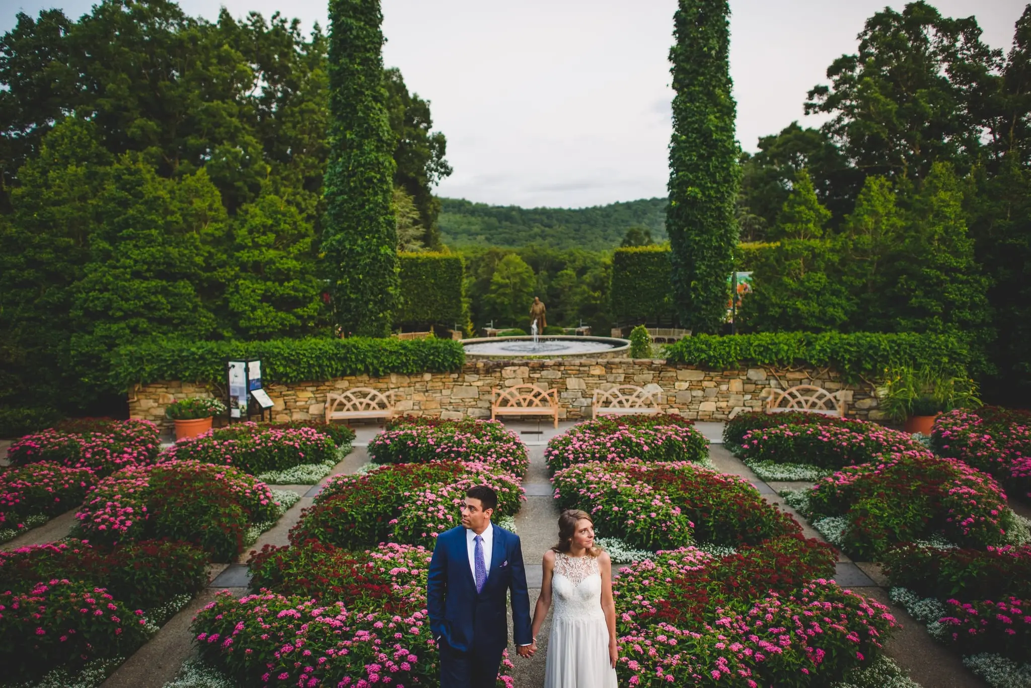 Couple walking between blooming beds in a formal garden at the North Carolina Arboretum