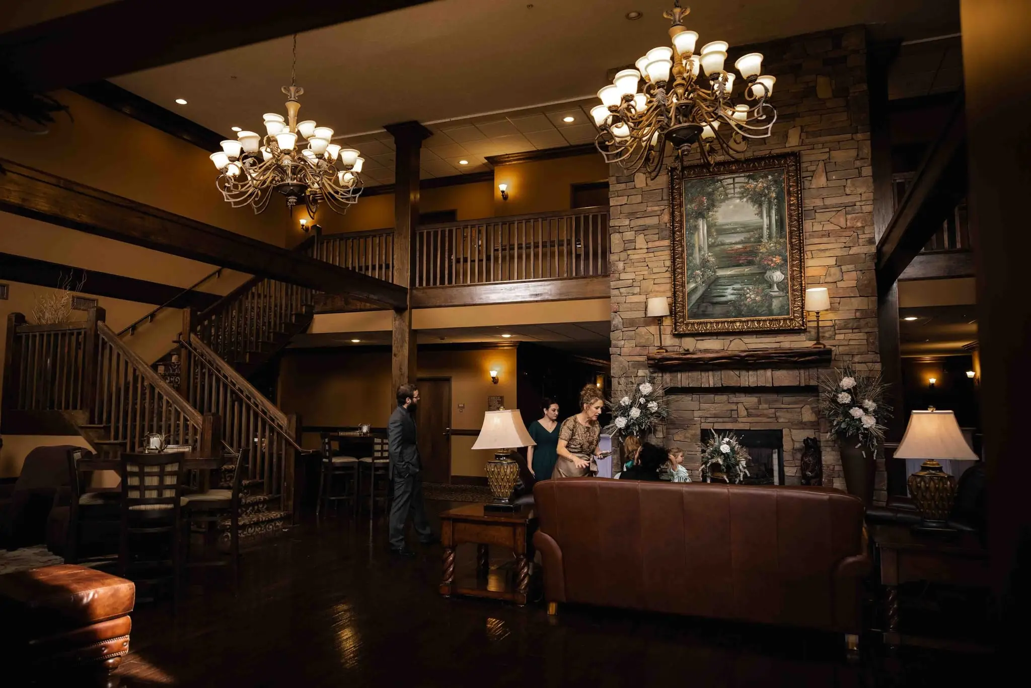 Lauren and Damian wedding at The Lodge at Flat Rock, Flat Rock NC — a wood-paneled lodge room with chandeliers and a balcony