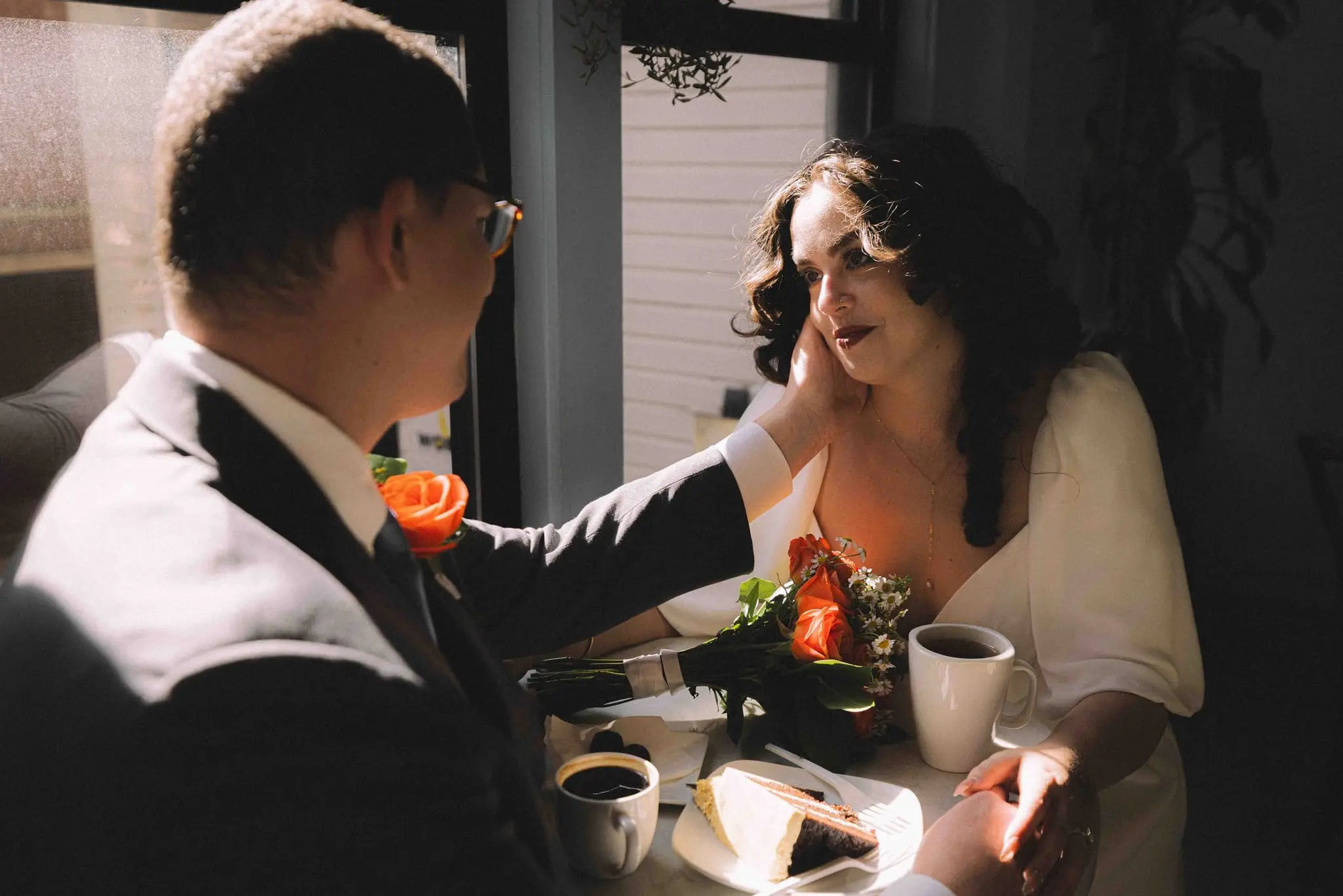 A newly married couple at a cafe table after their Asheville courthouse wedding