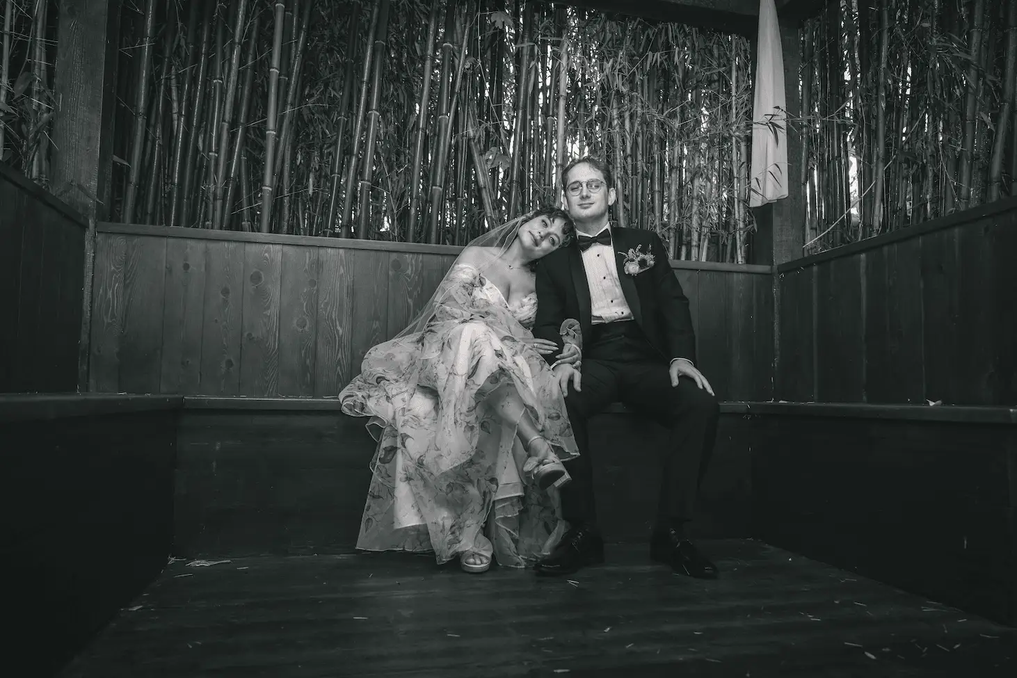 Maya and Jeff wedding at Weaver House, Weaverville NC — the couple sitting together in a bamboo-lined space, black and white