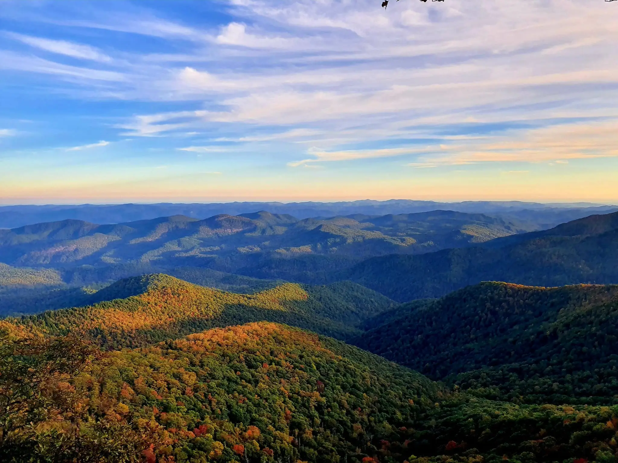 Sunset over layered Blue Ridge ridgelines and autumn forests from Max Patch
